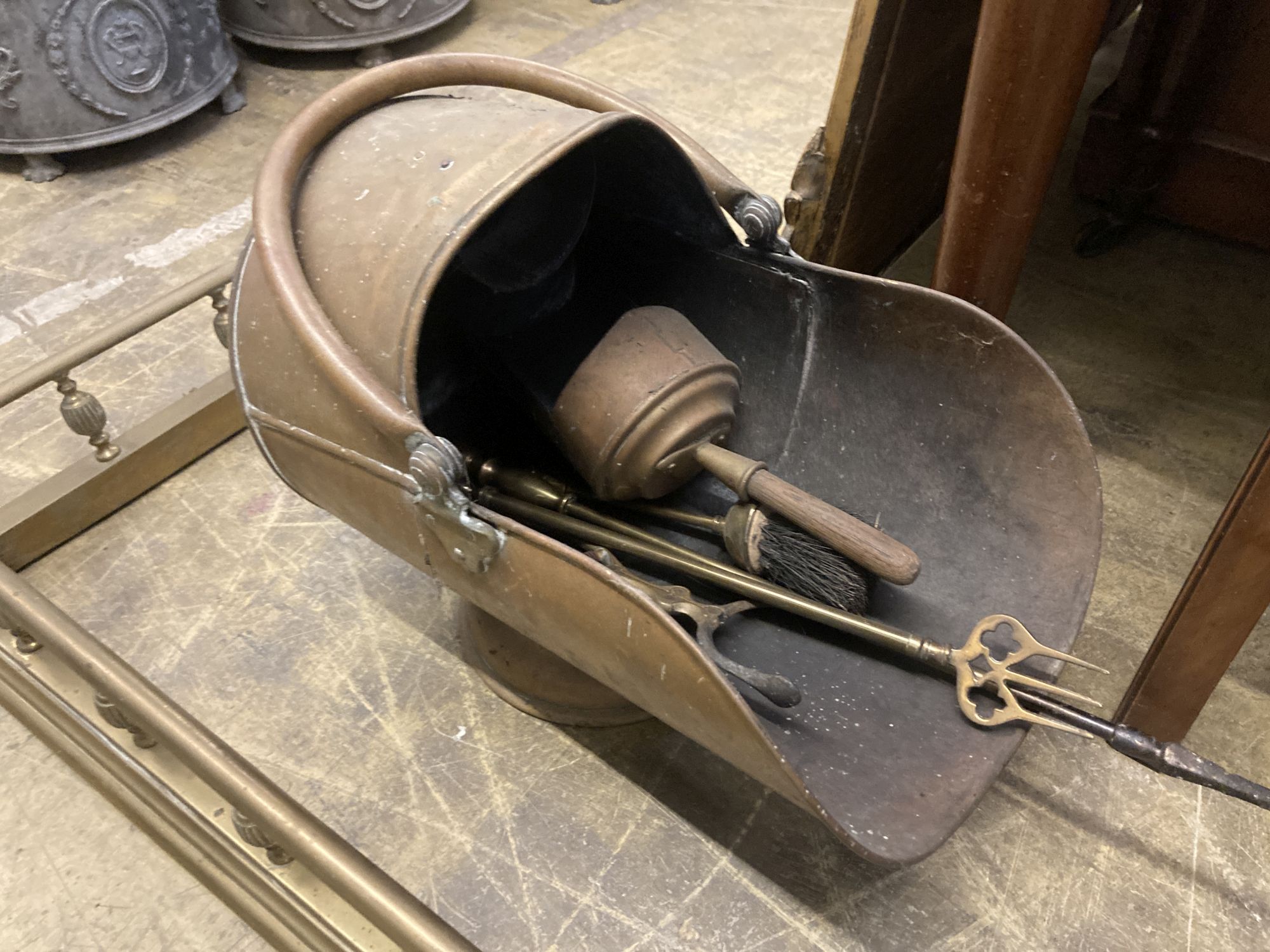 A Victorian brass kerb, length 140cm, together with a brass coal helmet and sundry brass fire implements